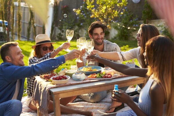 Friends sitting at a table with food and drinks