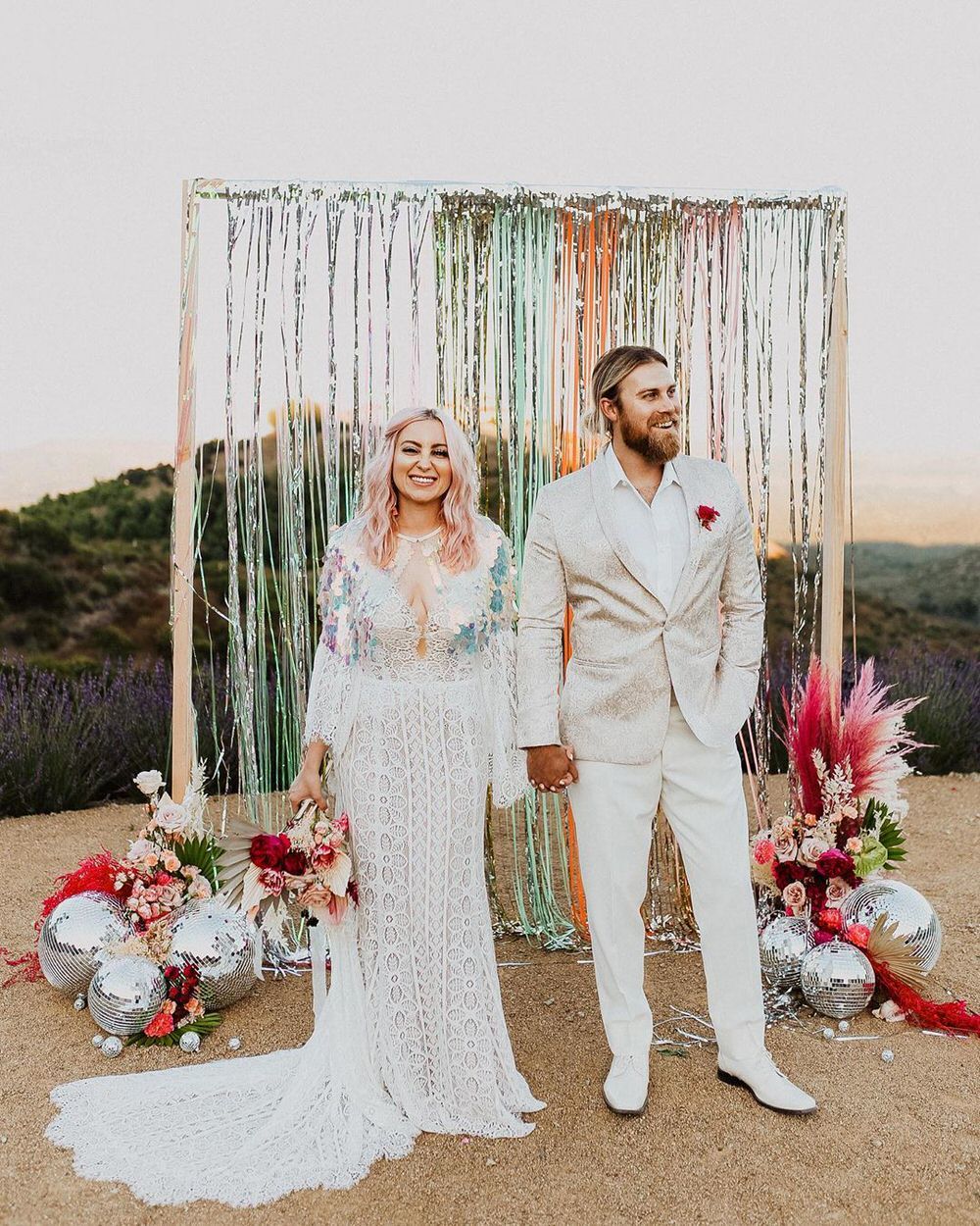 wedding alter decorated with streamers and disco balls