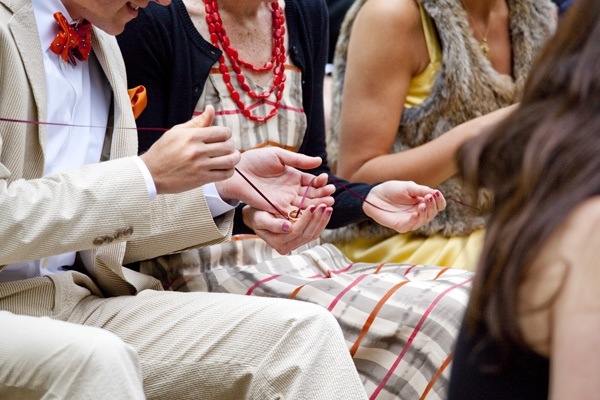 People passing a ring on a string