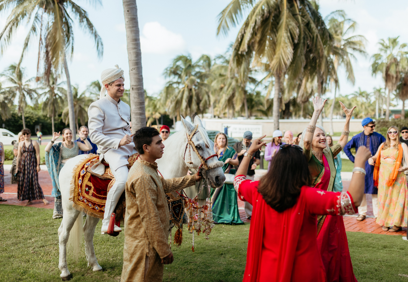 Traditional Indian wedding baraat with dancing guests in Playa del Carmen